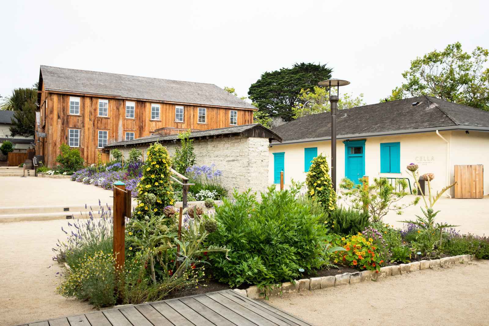 This is an image of site of Cooper Molera Adobe. The herb garden and The Barns at Cooper-Molera can also be seen in the image