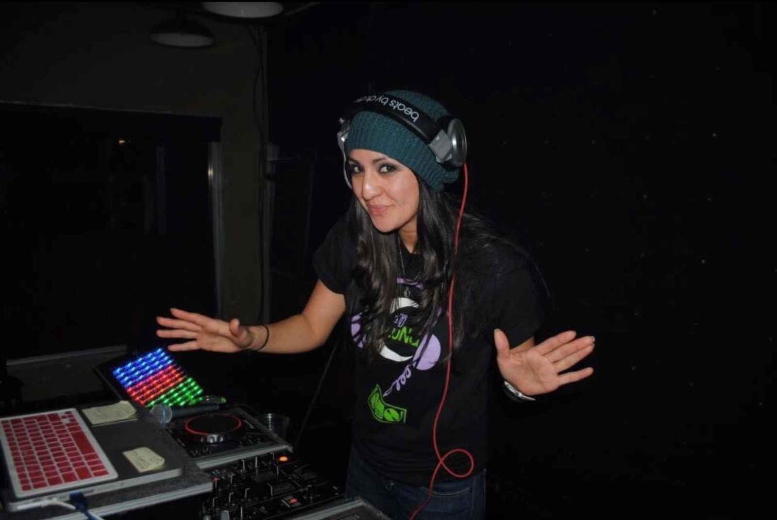 A woman wearing headphones in a dj booth