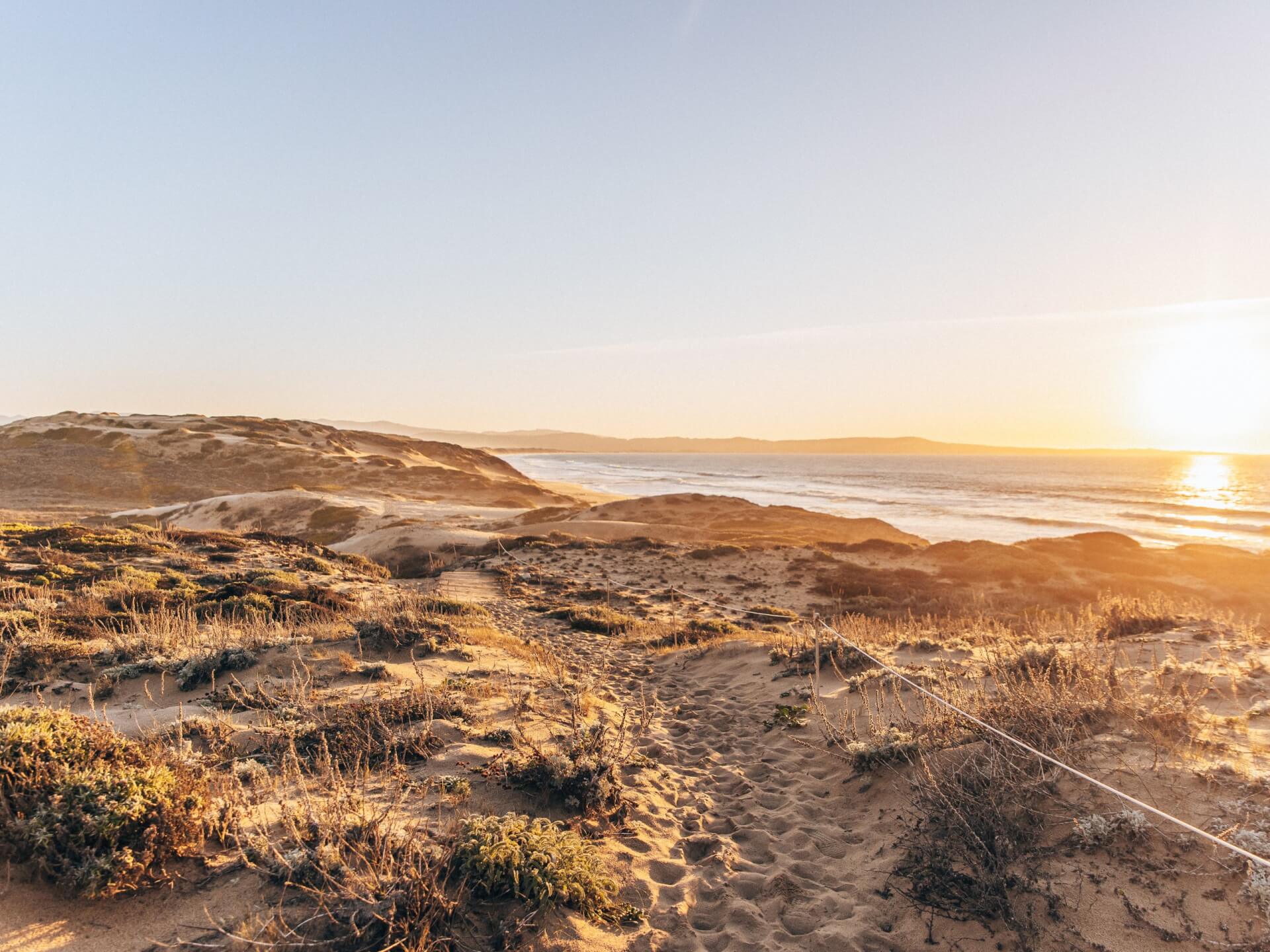 This is an image of the sand dunes, ocean and sunset from Fort Ord Dunes State Park in Marina, California