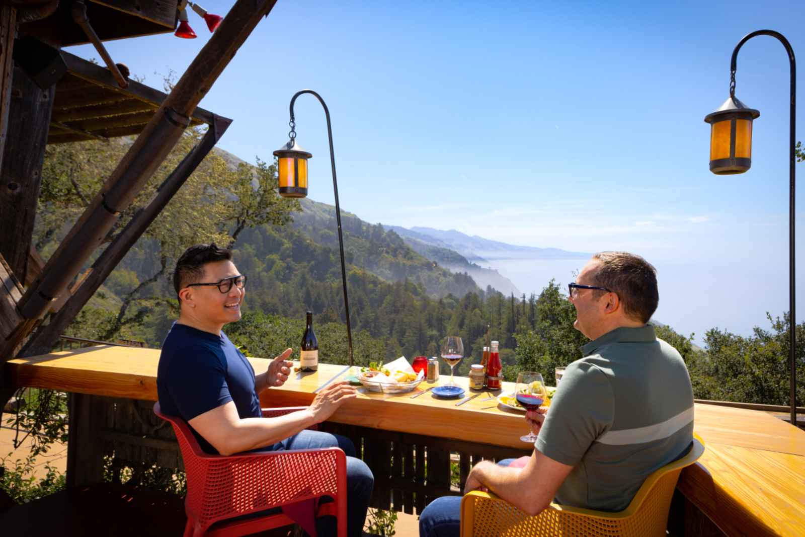 This is an image of a couple sharing a meal at Nepenthe Restaurant in Big Sur overlooking the dramatic Big Sur coast