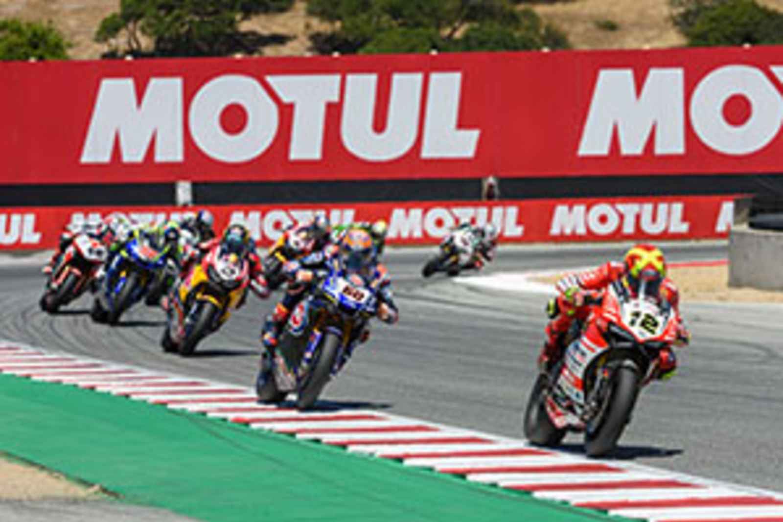 Professional motorcycle racers round the corner at WeatherTech Raceway Laguna Seca, CA